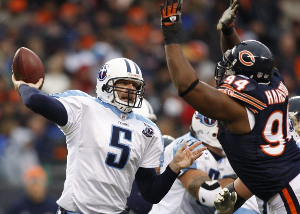 Nov 9, 2008; Chicago, IL, USA; Tennessee Titans quarterback Kerry Collins (5) throws a pass as he is pressured by Chicago Bears defensive tackle Marcus Harrison (94) during the third quarter at Soldier Field. The Titans beat the Bears 21-14.
