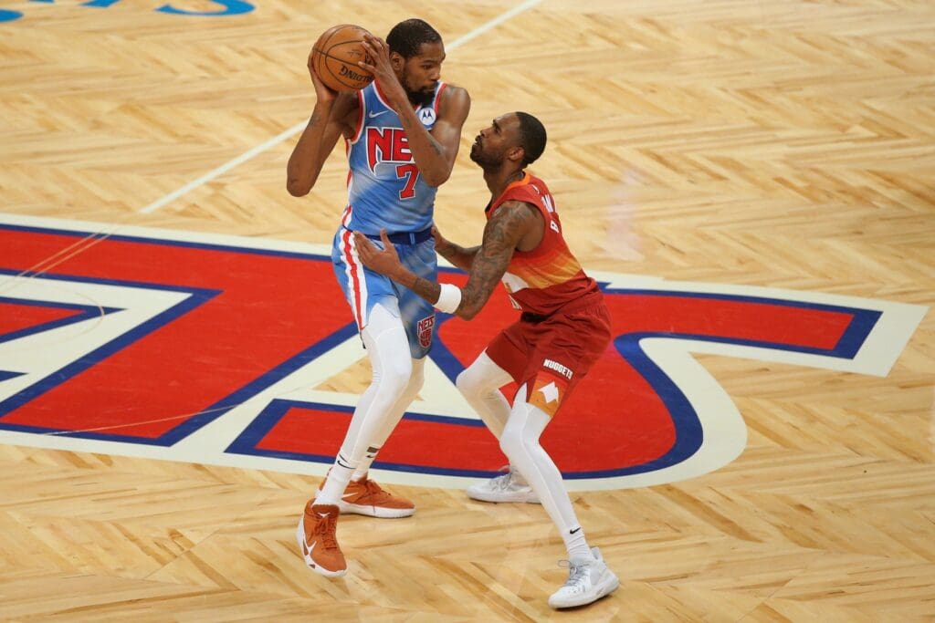 Jan 12, 2021; Brooklyn, New York, USA; Brooklyn Nets power forward Kevin Durant (7) controls the ball against Denver Nuggets small forward Will Barton (5) during the fourth quarter at Barclays Center.