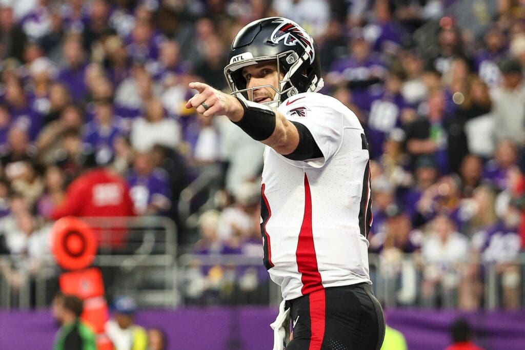 Dec 8, 2024; Minneapolis, Minnesota, USA; Atlanta Falcons quarterback Kirk Cousins (18) celebrates running back Bijan Robinson's (7) touchdown against the Minnesota Vikings during the third quarter at U.S. Bank Stadium.