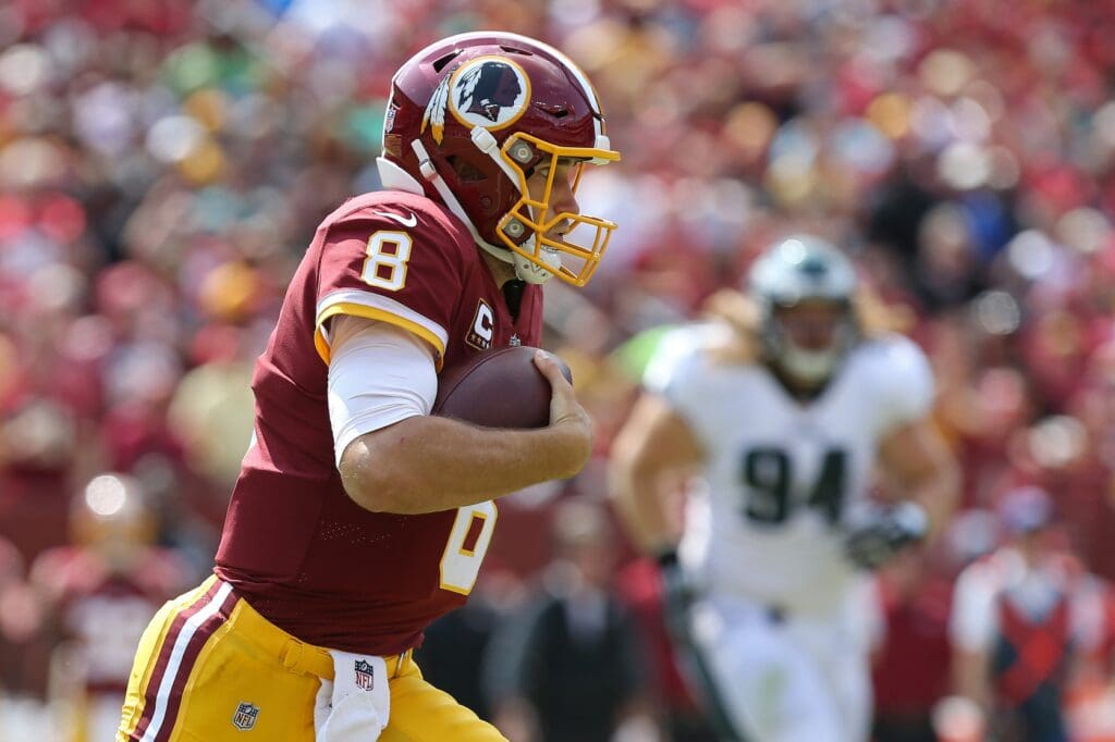 Sep 10, 2017; Landover, MD, USA; Washington Redskins quarterback Kirk Cousins (8) runs with the ball as Philadelphia Eagles defensive tackle Beau Allen (94) looks on in the second quarter at FedEx Field.