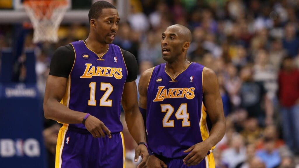 Feb 24, 2013; Dallas, TX, USA; Los Angeles Lakers guard Kobe Bryant (24) speaks with center Dwight Howard (12) during the game against the Dallas Mavericks at the American Airlines Center.