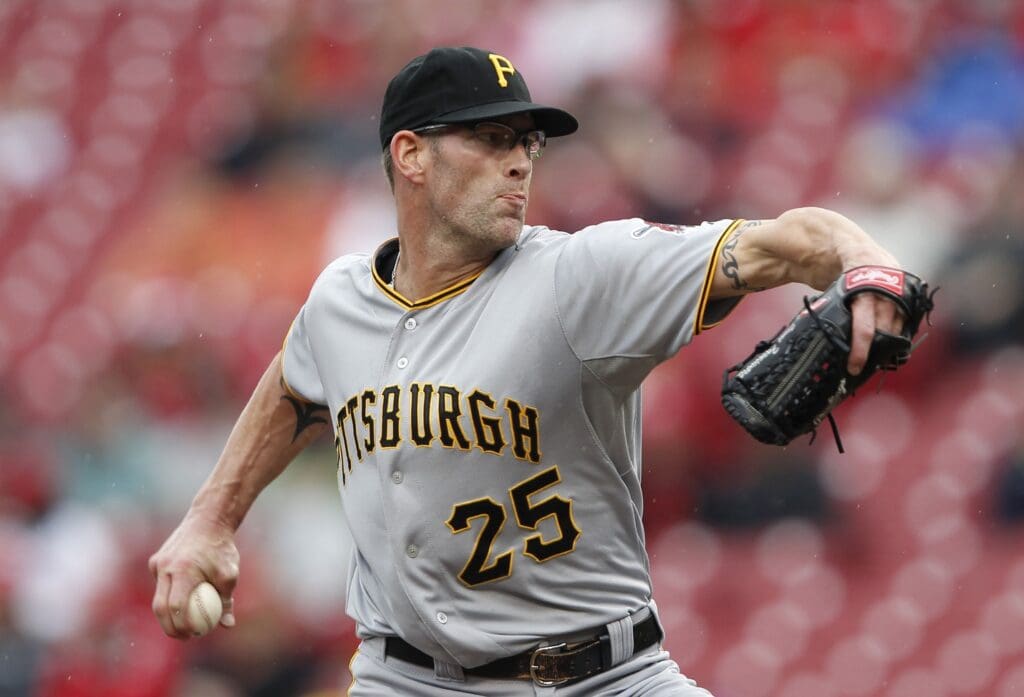 Sep 29, 2013; Cincinnati, OH, USA; Pittsburgh Pirates relief pitcher Kyle Farnsworth (25) pitches during the ninth inning against the Cincinnati Reds at Great American Ball Park. The Pirates defeated the Reds 4-2.