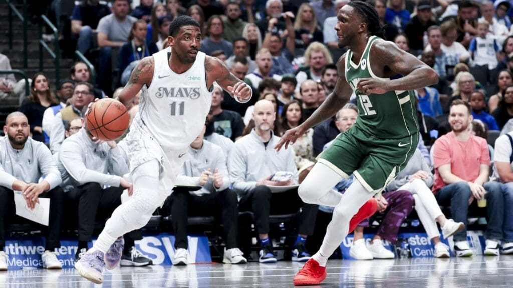 Mar 1, 2025; Dallas, Texas, USA; Dallas Mavericks guard Kyrie Irving (11) dribbles as Milwaukee Bucks forward Taurean Prince (12) defends during the first half at American Airlines Center.