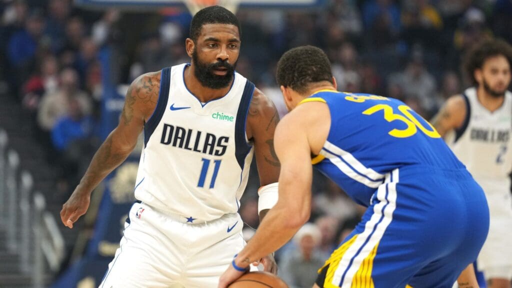 Dec 15, 2024; San Francisco, California, USA; Dallas Mavericks guard Kyrie Irving (11) defends against Golden State Warriors guard Stephen Curry (30) during the first quarter at Chase Center.