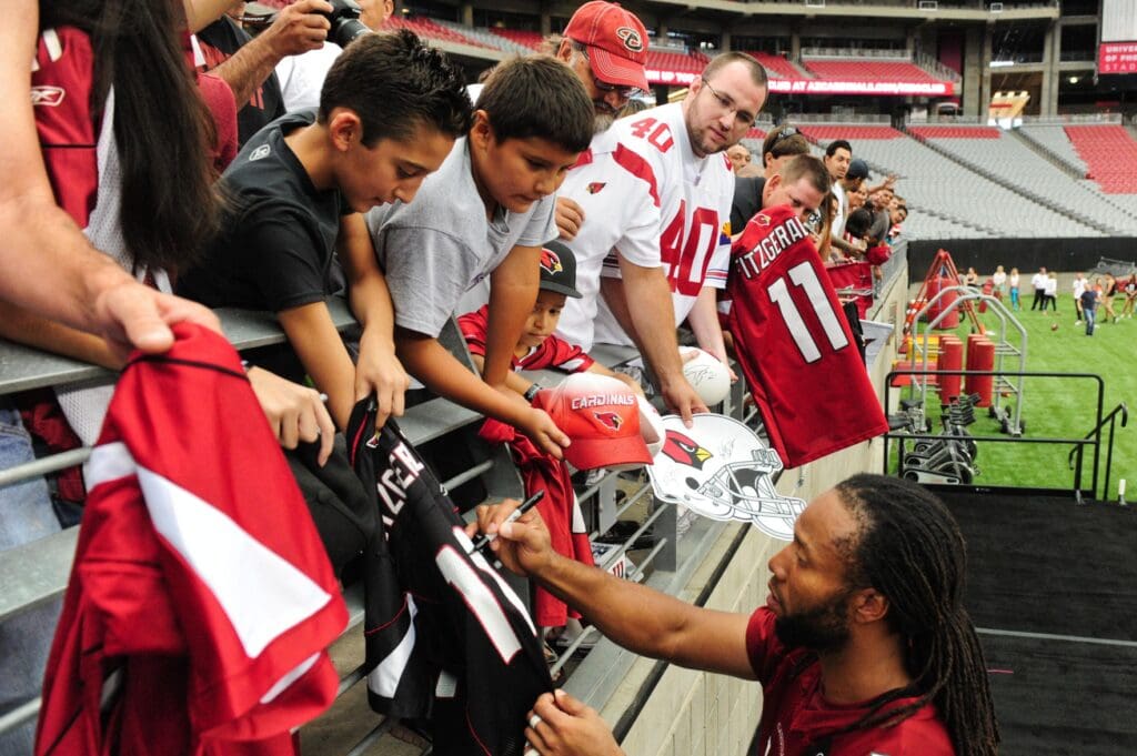 Jul 26, 2014; Tempe, AZ, USA; Arizona Cardinals wide receiver Larry Fitzgerald (11) signs autographs for fans during training camp at University of Phoenix.