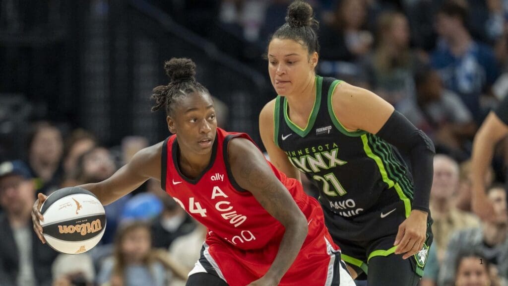 Jun 17, 2025; Minneapolis, Minnesota, USA; Las Vegas Aces guard Jewell Loyd (24) dribbles the ball as Minnesota Lynx guard Kayla McBride (21) plays defense in the second half at Target Center.