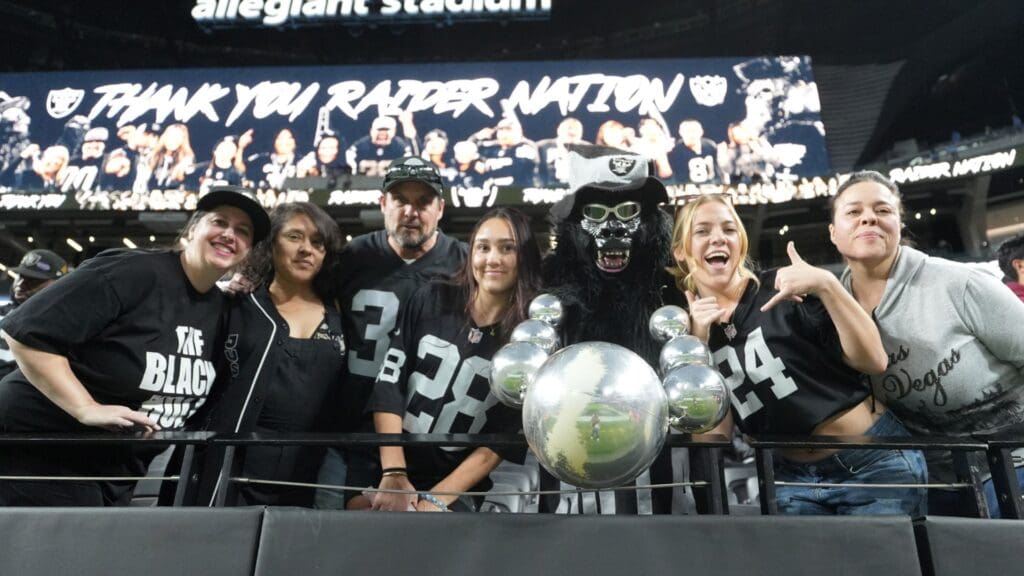 Jan 5, 2025; Paradise, Nevada, USA; Las Vegas Raiders fans (from left) Marilyn Acasio aka Jungle Jane, Maria Lopez, Geoff Skarr, Alyssa Skarr, Mark Acasio aka Gorilla Rilla, Amber Mielke and Monica Martinez pose during the game against the Los Angeles Chargers at Allegiant Stadium.