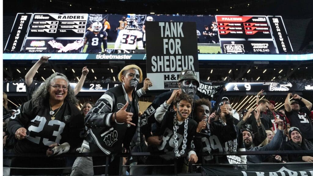 Dec 16, 2024; Paradise, Nevada, USA; Las Vegas Raiders fans hold a sign that reads Tank for Shedeur Sanders during the game against the Atlanta Falcons at Allegiant Stadium.
