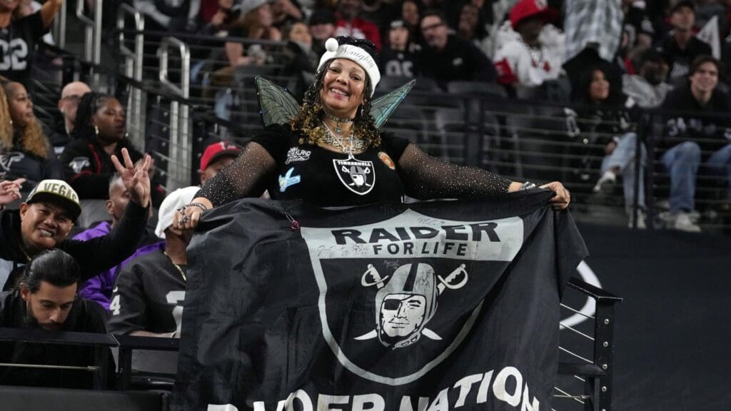 Dec 16, 2024; Paradise, Nevada, USA; A Las Vegas Raiders fan holds a flag during a game against the Atlanta Falcons in the second half at Allegiant Stadium.