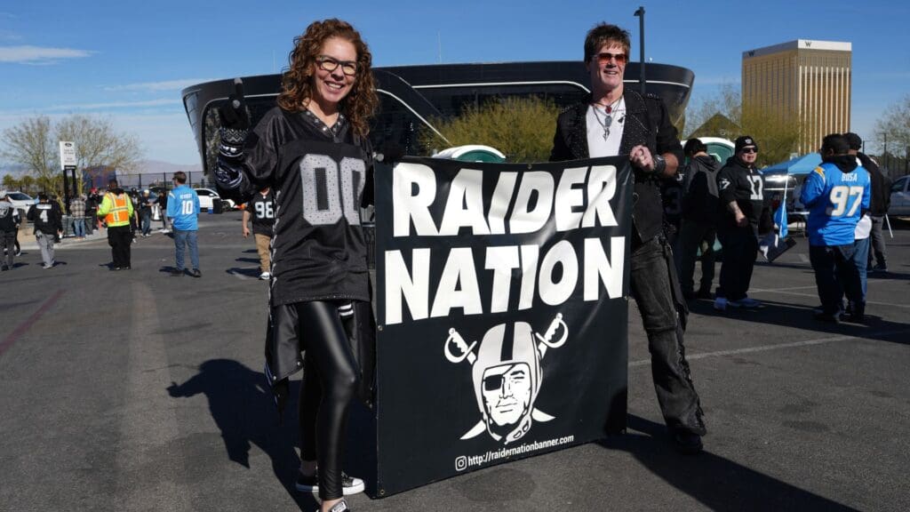 Jan 5, 2025; Paradise, Nevada, USA; Las Vegas Raiders fans hold a Raider Nation banner during tailgate festivities before the game against the Los Angeles Chargers at Allegiant Stadium.