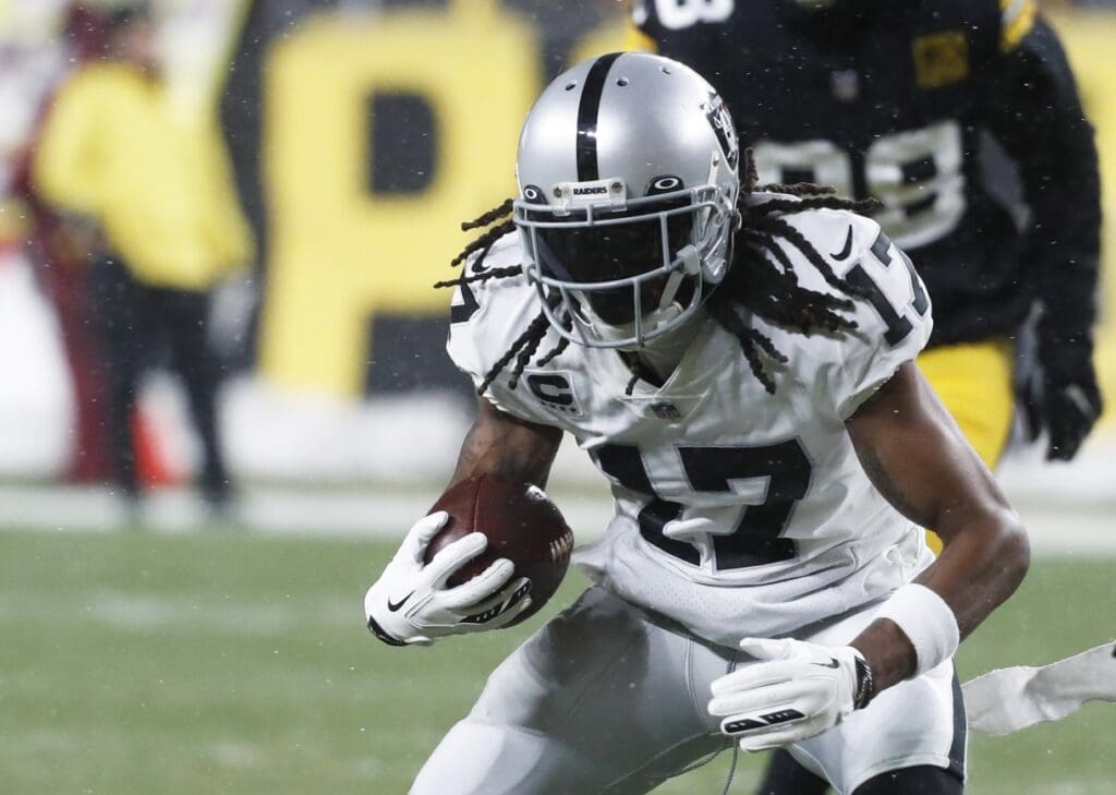 Dec 24, 2022; Pittsburgh, Pennsylvania, USA; Las Vegas Raiders wide receiver Davante Adams (17) runs after a catch against the Pittsburgh Steelers during the first quarter at Acrisure Stadium.