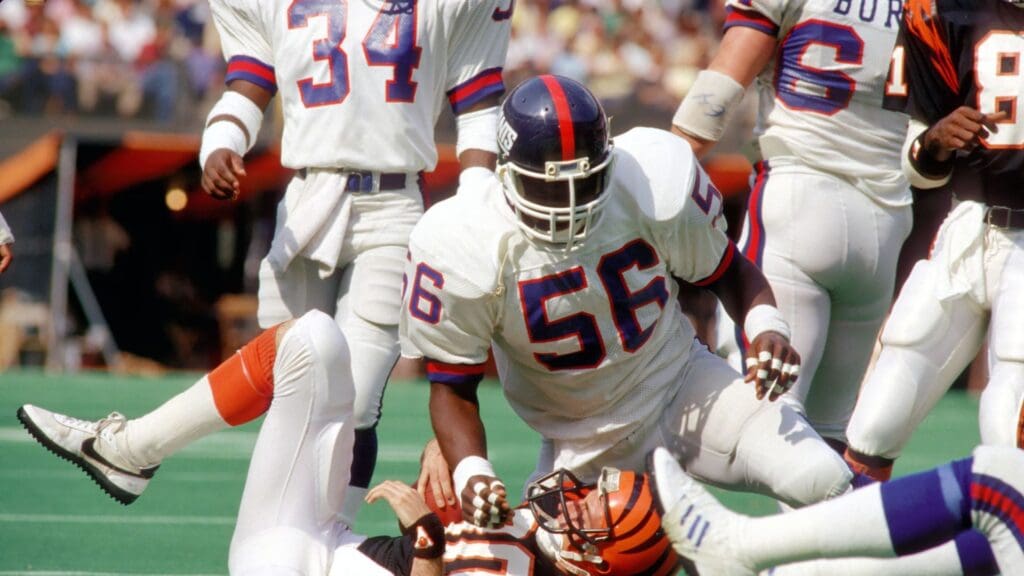 Oct 13, 1985; Cincinnati, OH, USA; FILE PHOTO; New York Giants Linebacker (56) LAWRENCE TAYLOR tackles Cincinnati Bengals Receiver (80) CRIS COLLINSWORTH at Riverfront Stadium. The Bengals defeated the Giants 35-30.