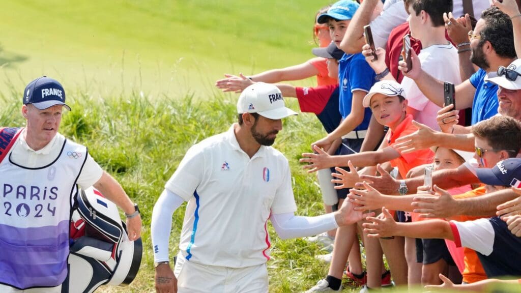 Aug 2, 2024; Saint-Quentin-en-Yvelines, France; Matthieu Pavon of Team France high fives fans as he walks to the 7th tee in round two of menís stroke play during the Paris 2024 Olympic Summer Games at Le Golf National
