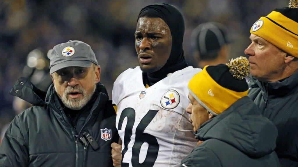 Nov 28, 2013; Baltimore, MD, USA; Pittsburgh Steelers running back LeVeon Bell (26) is led off the field by team staff after has his helmet was knocked off in the fourth quarter against the Baltimore Ravens during a NFL football game on Thanksgiving at M&T Bank Stadium.