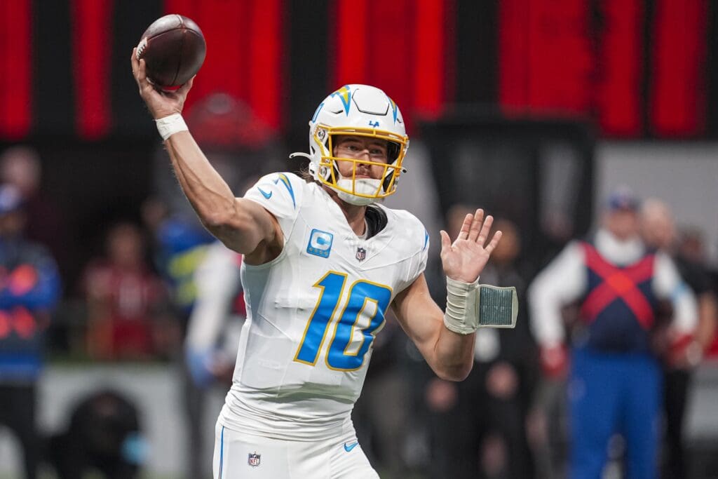 Dec 1, 2024; Atlanta, Georgia, USA; Los Angeles Chargers quarterback Justin Herbert (10) passes against the Atlanta Falcons during the first quarter at Mercedes-Benz Stadium.