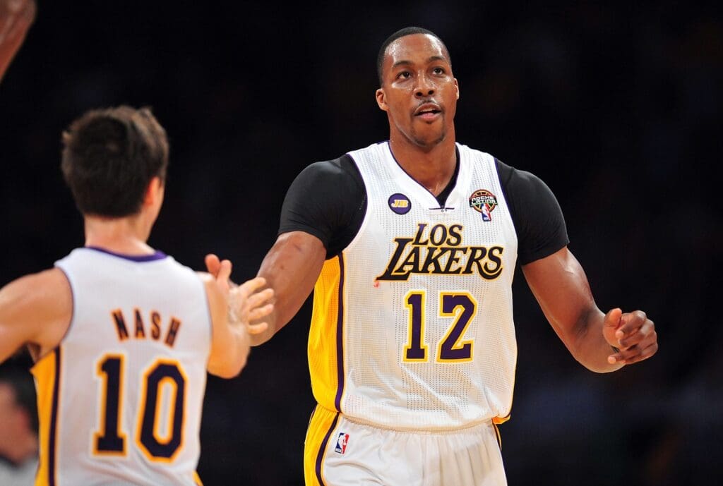 March 10, 2013; Los Angeles, CA, USA; Los Angeles Lakers center Dwight Howard (12) celebrates with point guard Steve Nash (10) after scoring a basket against the Chicago Bulls during the first half at Staples Center.