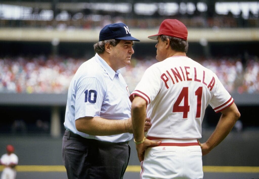 1990, Cincinnati, OH, USA; FILE PHOTO; Cincinnati Reds manager Lou Piniella (41) talks with MLB umpire John McSherry at Riverfront Stadium during the 1990 season.