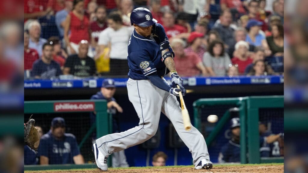 Aug 16, 2019; Philadelphia, PA, USA; San Diego Padres third baseman Manny Machado (13) hits a single during the sixth inning against the Philadelphia Phillies at Citizens Bank Park.