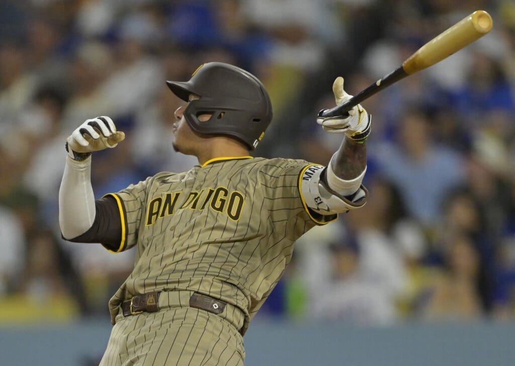 Jun 16, 2025; Los Angeles, California, USA; San Diego Padres third baseman Manny Machado (13) flips his bat after hitting a solo home run in the sixth inning against the Los Angeles Dodgers at Dodger Stadium.