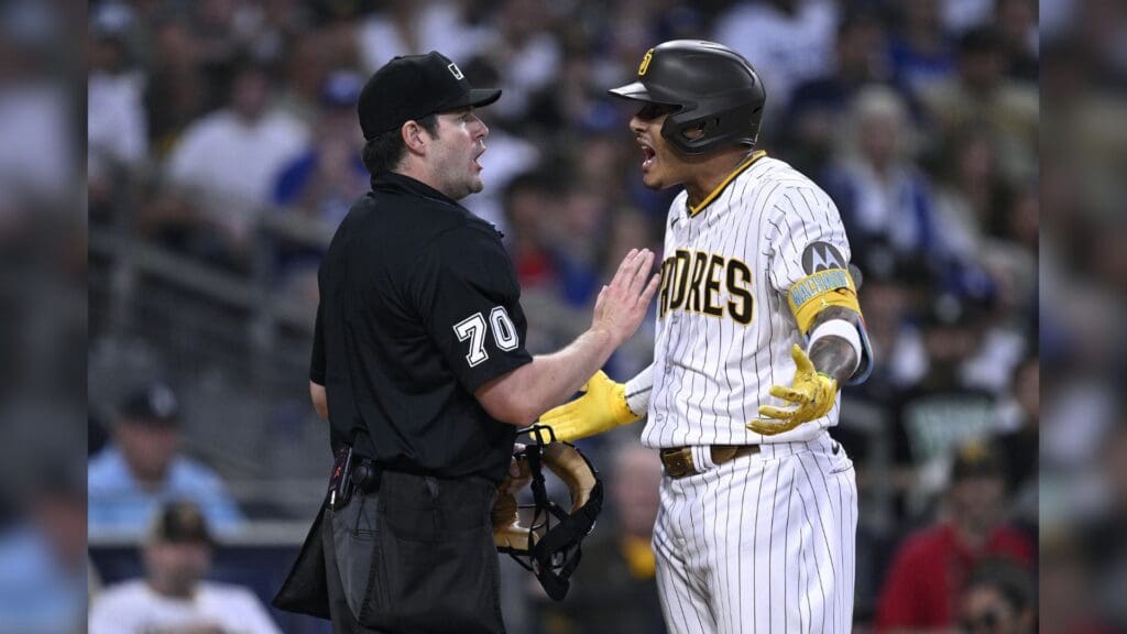 Aug 4, 2023; San Diego, California, USA; San Diego Padres third baseman Manny Machado (right) talks to home plate umpire John Bacon (70) after striking out to end the sixth inning against the Los Angeles Dodgers at Petco Park.