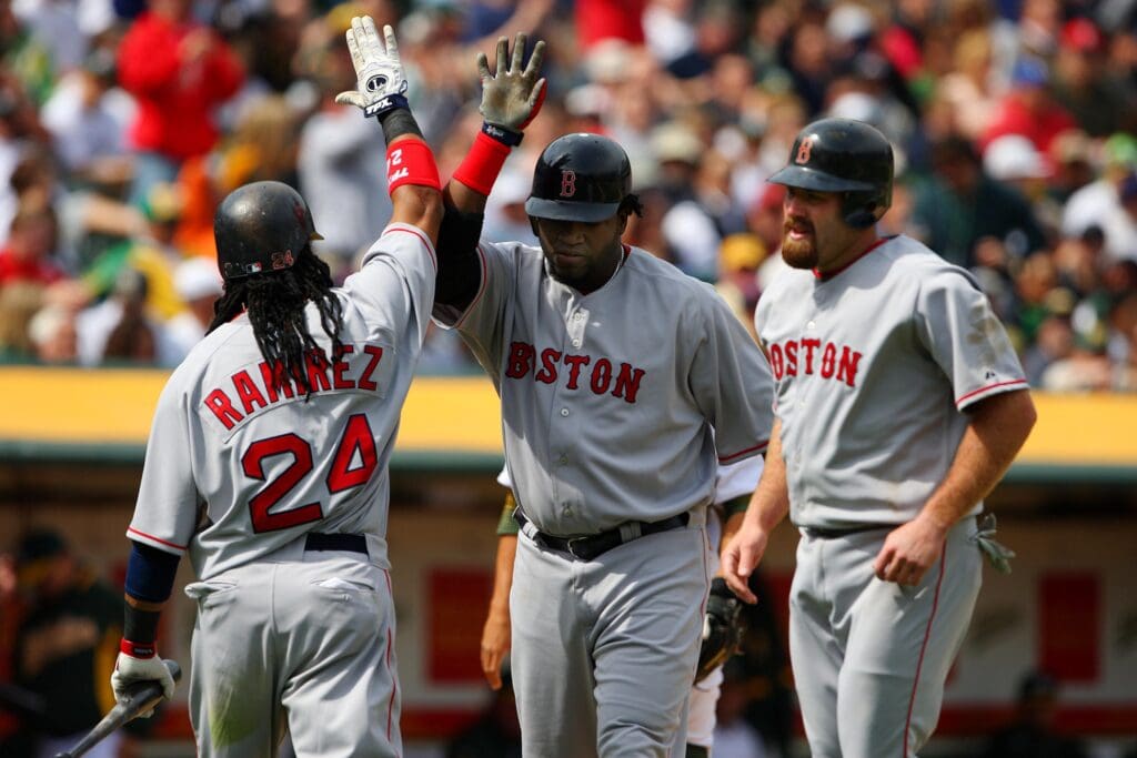Apr. 2, 2008; Oakland, CA, USA; Boston Red Sox designated hitter David Ortiz (center) is congratulated by left fielder Manny Ramirez (24) and first baseman Kevin Youkilis (20) after hitting a two-run home run against the Oakland Athletics during the 7th inning at McAfee Coliseum in Oakland, CA