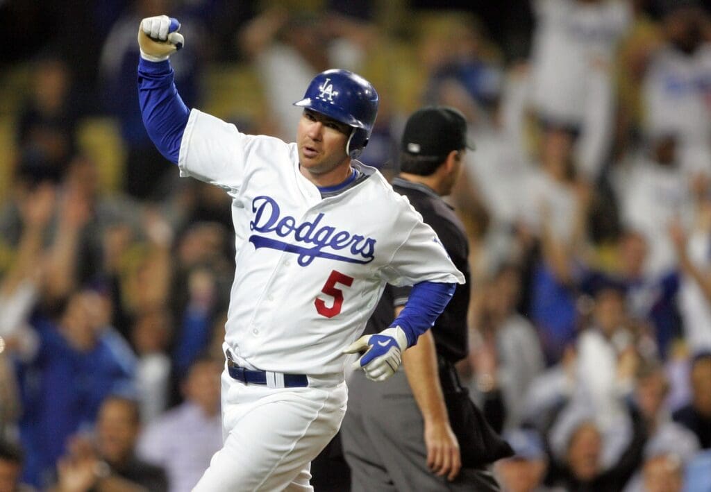 May 18, 2009; Los Angeles, CA, USA; Los Angeles Dodgers second baseman Mark Loretta (5) celebrates after crossing home plate to score the game-winning run in the eleventh inning against the New York Mets at Dodger Stadium. Los Angeles defeats New York 3-2.