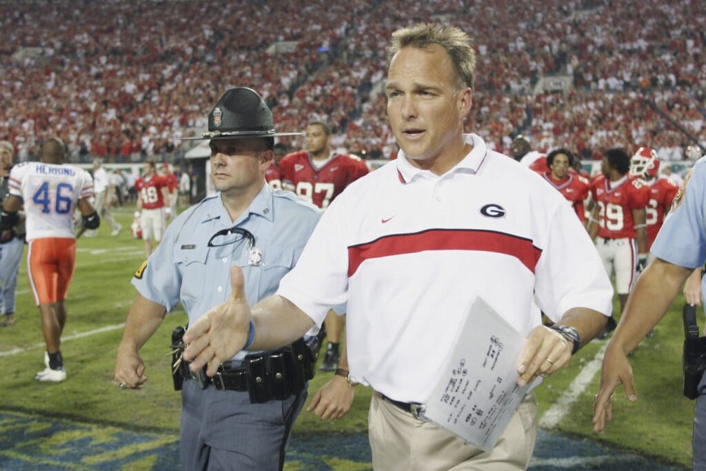 Oct 30, 2004; Jacksonville, FL, USA; University of Georgia coach Mark Richt runs to console Florida Gators coach Ron Zook at Alltel Stadium.