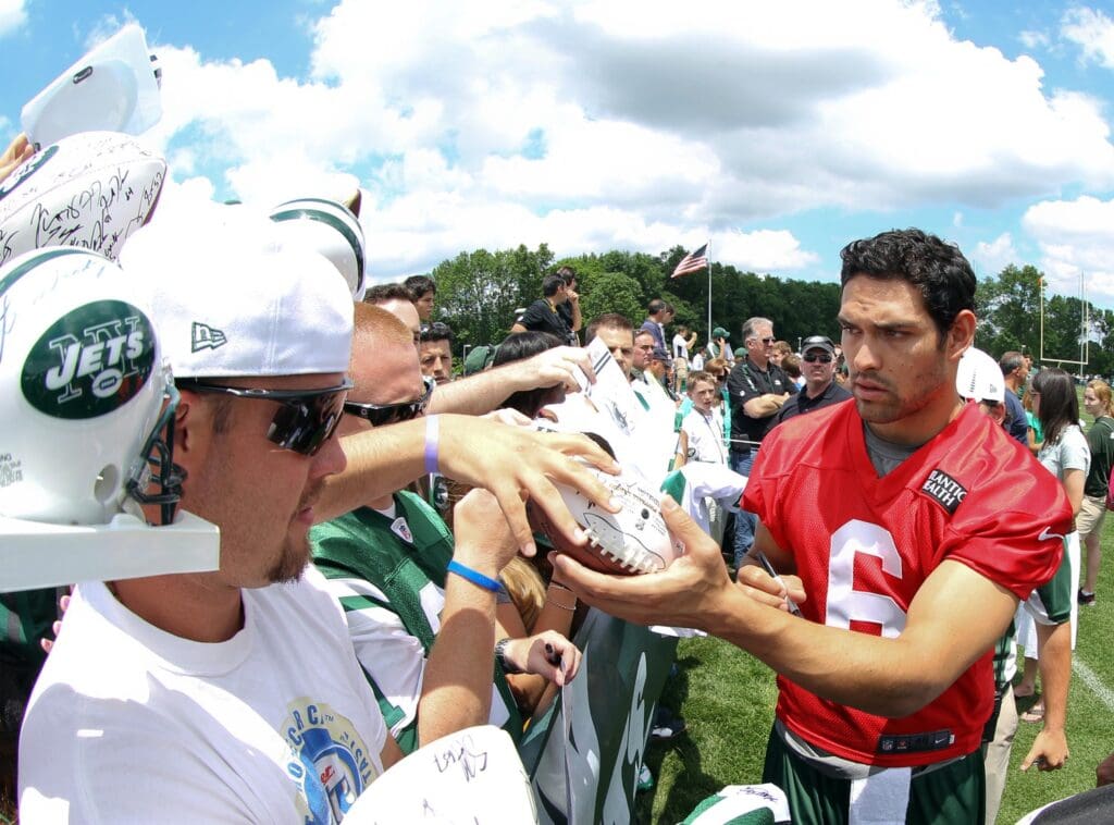June 14, 2012; Florham Park, NJ, USA; New York Jets quarterback Mark Sanchez (6) signs autographs for fans during minicamp at the Atlantic Health Training Center.