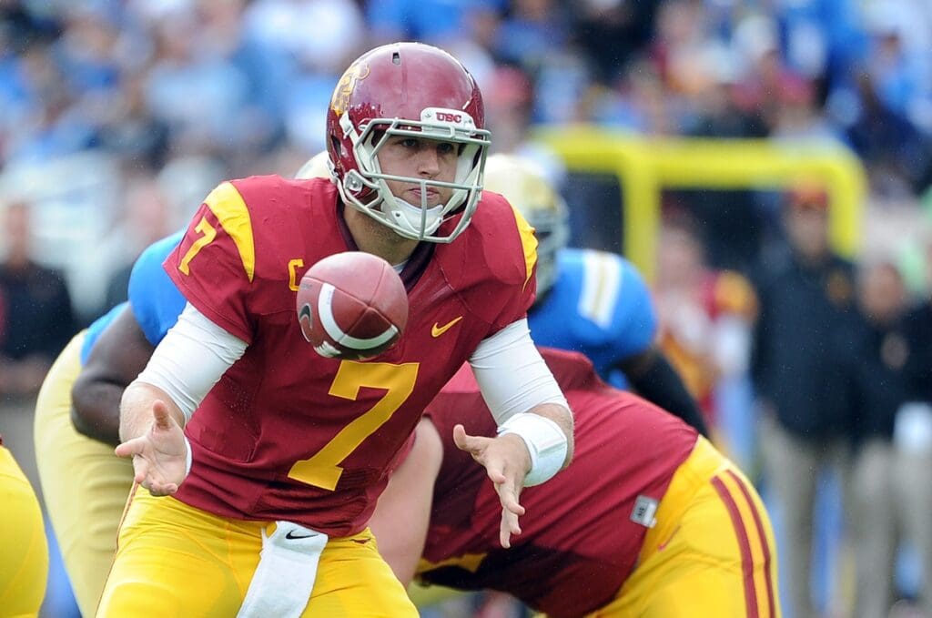 November 17, 2012; Pasadena, CA, USA; USC Trojans quarterback Matt Barkley (7) hands off the ball in the first half of the game against the UCLA Bruins at the Rose Bowl.