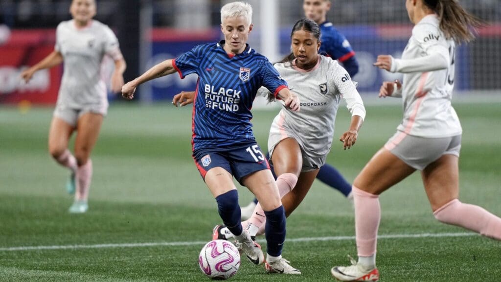Oct 20, 2023; Seattle, Washington, USA; OL Reign forward Megan Rapinoe (15) dribbles the ball against Angel City FC defender Madison Hammond (99) at Lumen Field.