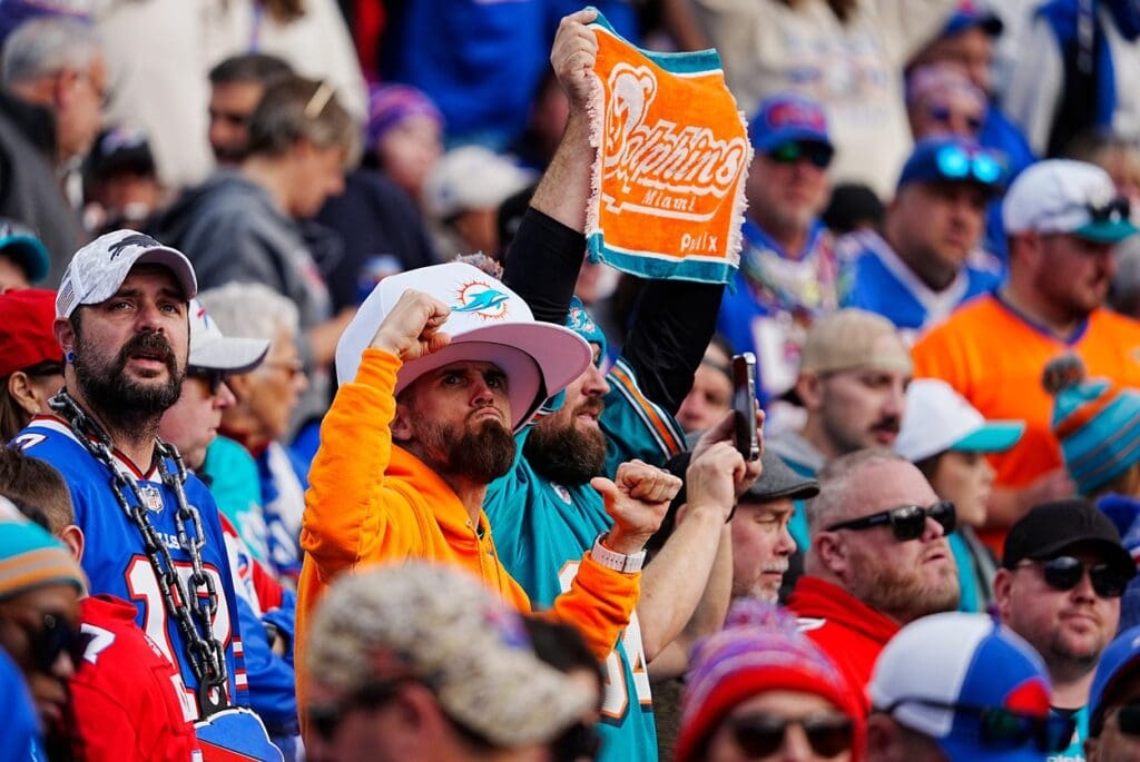 Miami Dolphin fans cheer on their team from behind the Miami bench during second half action at Highmark Stadium on Nov. 3, 2024.