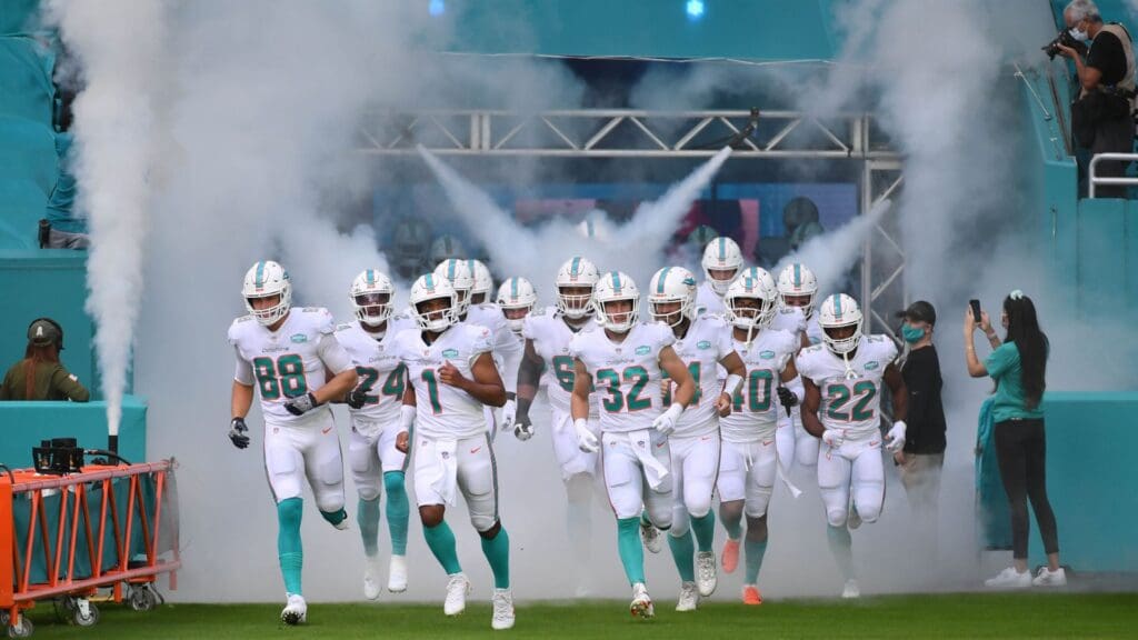 Nov 1, 2020; Miami Gardens, Florida, USA; Miami Dolphins quarterback Tua Tagovailoa (1) leads his team out to the field before the game against the Los Angeles Rams at Hard Rock Stadium.