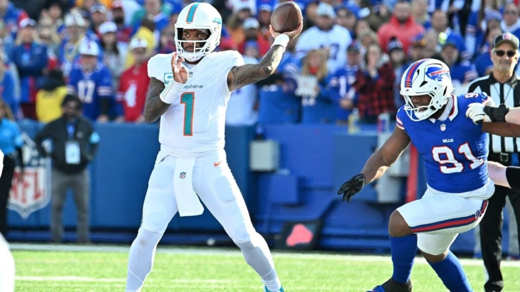Nov 3, 2024; Orchard Park, New York, USA; Miami Dolphins quarterback Tua Tagovailoa (1) throws a pass with Buffalo Bills defensive tackle Ed Oliver (91) nearby in the second quarter at Highmark Stadium.