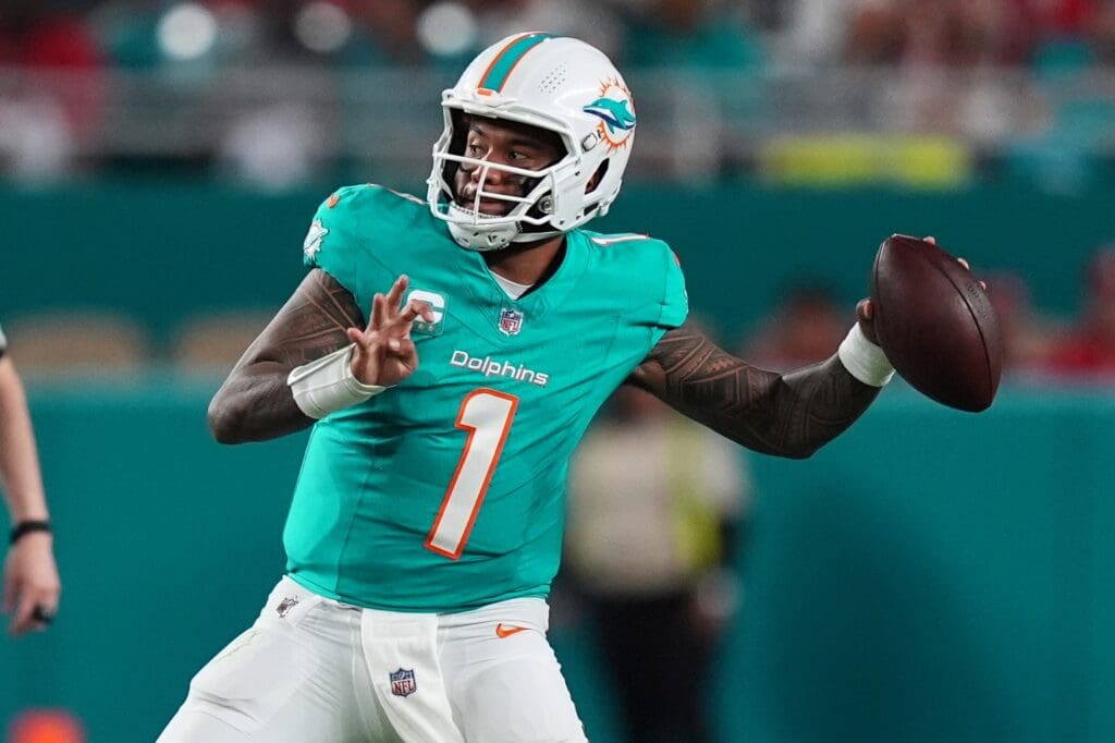 Dec 22, 2024; Miami Gardens, Florida, USA; Miami Dolphins quarterback Tua Tagovailoa (1) attempts a pass against the San Francisco 49ers during second half at Hard Rock Stadium