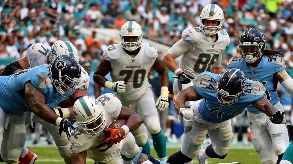 Sep 9, 2018; Miami Gardens, FL, USA; Miami Dolphins running back Kenyan Drake (32) pushes for yardage against the Tennessee Titans during the second half at Hard Rock Stadium