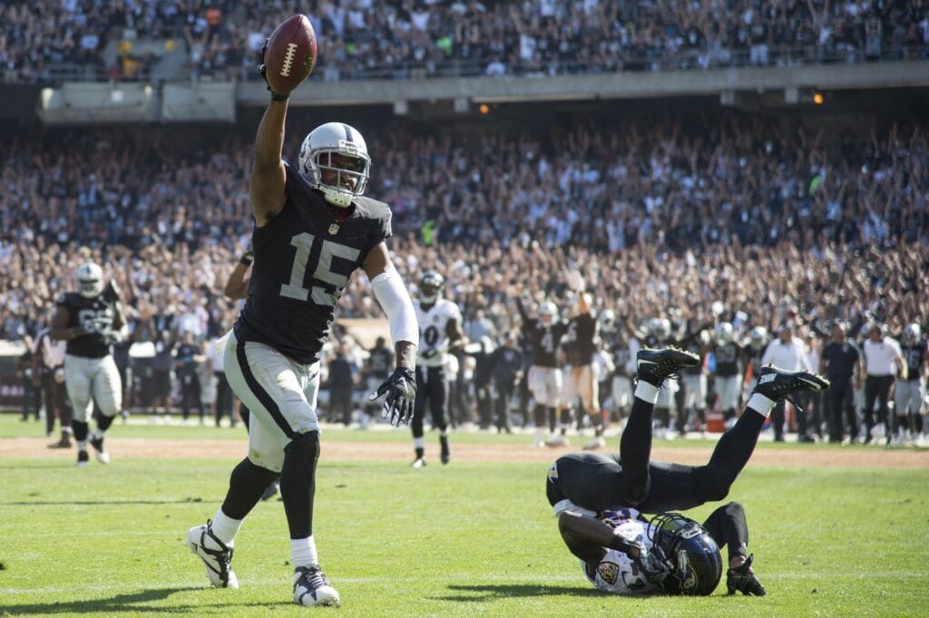 September 20, 2015; Oakland, CA, USA; Oakland Raiders wide receiver Michael Crabtree (15) scores a touchdown against Baltimore Ravens defensive back Kyle Arrington (24, right) during the third quarter at O.co Coliseum. The Raiders defeated the Ravens 37-33