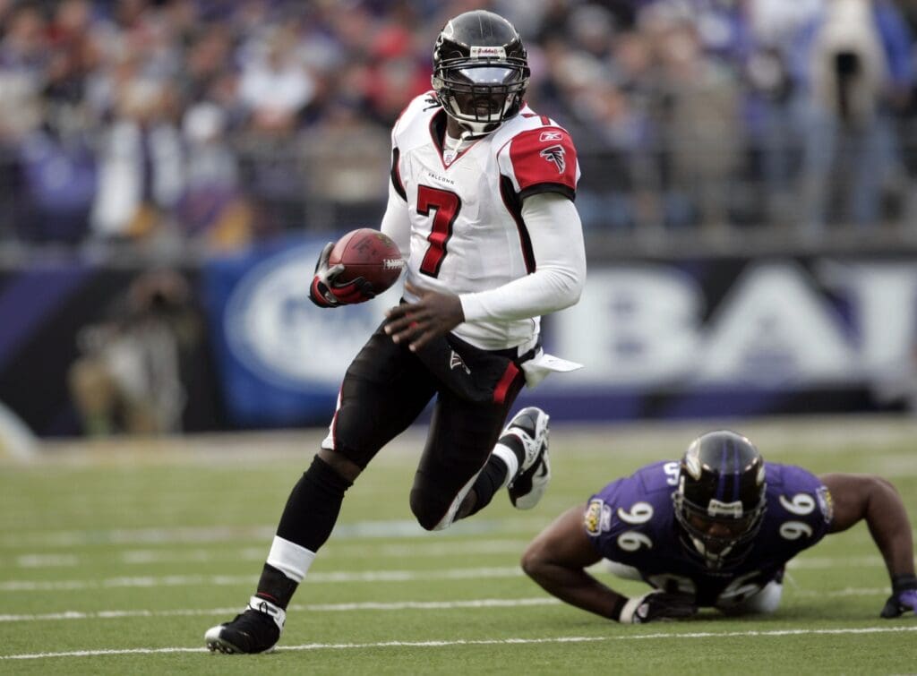 Nov 19, 2006; Baltimore, MD, USA; Atlanta Falcons quarterback (7) Michael Vick carries the ball as Baltimore Ravens linebacker (96)Adalius Thomas falls to the ground in the third quarter at M&T Bank Stadium in Baltimore, MD.