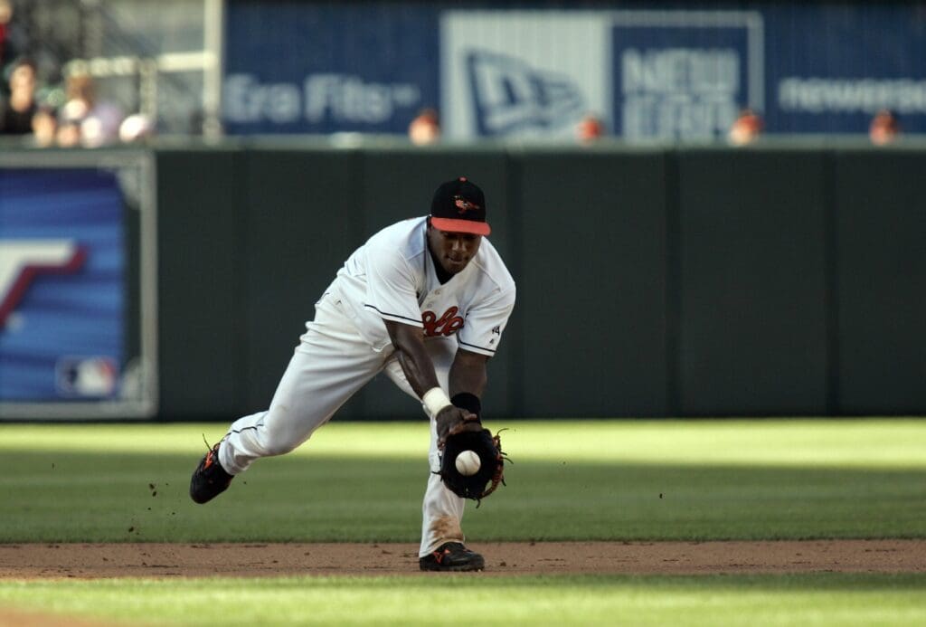 August 5, 2006; Baltimore, MD, USA; Baltimore Orioles shortstop (10) Miguel Tejada fields a ground ball for the out at first base over Melky Cabrera (not pictured) in the fifth inning at Camden Yards in Baltimore, Maryland.