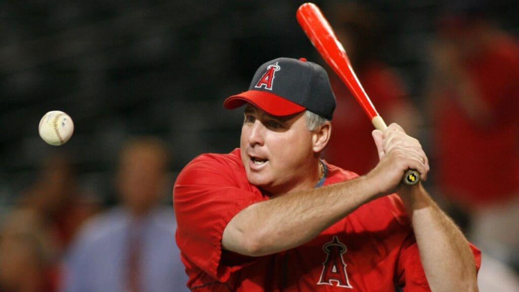June 23, 2006; Phoenix, AZ, USA; Los Angeles Angels of Anaheim manager (14) Mike Scioscia hits grounders before playing the Arizona Diamondbacks at Chase Field.