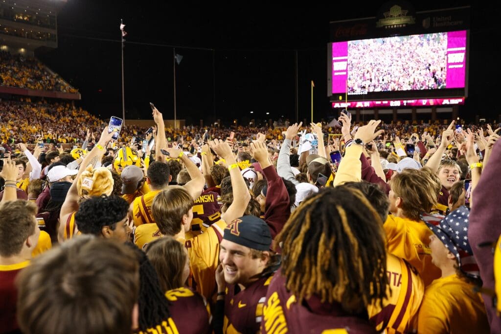 Minnesota Golden Gophers fans celebrate on the field after the game against the USC Trojans at Huntington Bank Stadium.