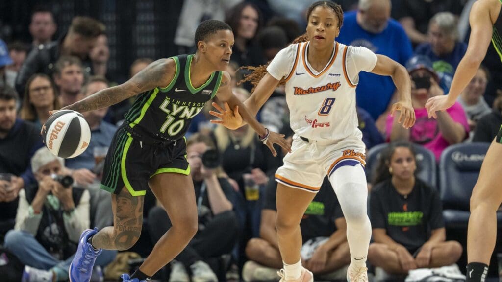 Jun 3, 2025; Minneapolis, Minnesota, USA; Minnesota Lynx guard Courtney Williams (10) dribbles the ball past Phoenix Mercury guard Monique Akoa Makani (8) in the second half at Target Center.