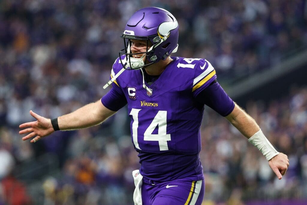 Dec 8, 2024; Minneapolis, Minnesota, USA; Minnesota Vikings quarterback Sam Darnold (14) celebrates running back Aaron Jones' (33) touchdown run against the Atlanta Falcons during the fourth quarter at U.S. Bank Stadium.