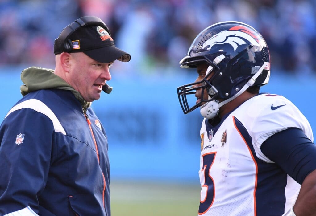 Nov 13, 2022; Nashville, Tennessee, USA; Denver Broncos head coach Nathaniel Hackett talks with quarterback Russell Wilson (3) during a timeout during the second half against the Tennessee Titans at Nissan Stadium.