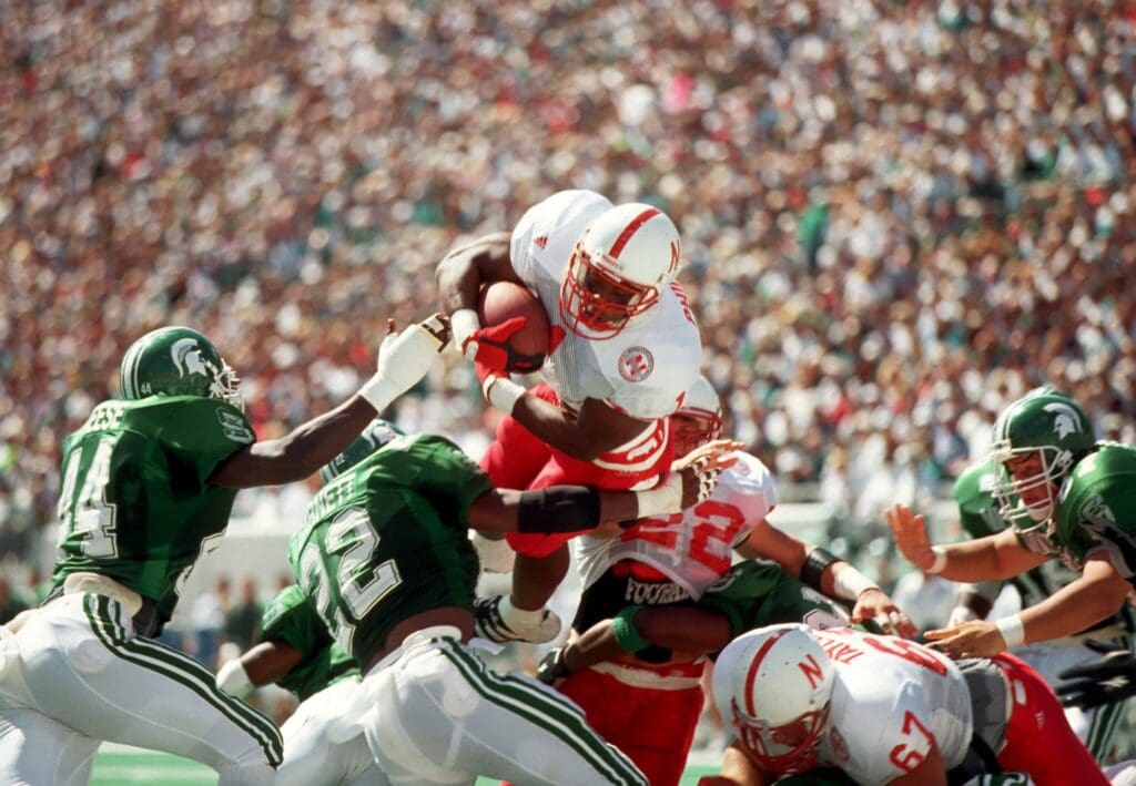 Nebraska Cornhuskers running back Lawrence Phillips (1) dives for a touchdown against the Michigan State Spartans at Spartan Stadium