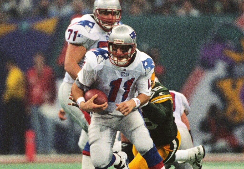 Jan 26, 1997; New Orleans, LA, USA; FILE PHOTO; New England Patriots quarterback Drew Bledsoe (11) carries the ball against the Green Bay Packers during Super Bowl XXXI at the Superdome. The Packers defeated the Patriots 35-21.