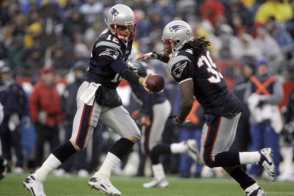 New England Patriots quarterback Tom Brady (12) hands off the ball the running back Laurence Maroney (39) in the 3rd quarter against the New York Jets at Gillette Stadium. Patriots defeated the Jets 20-10.