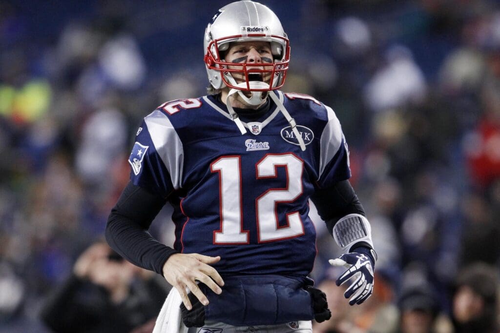 Jan 14, 2012; Foxborough, MA, USA; New England Patriots quarterback Tom Brady (12) warms up before the 2011 AFC divisional playoff game against the Denver Broncos at Gillette Stadium.