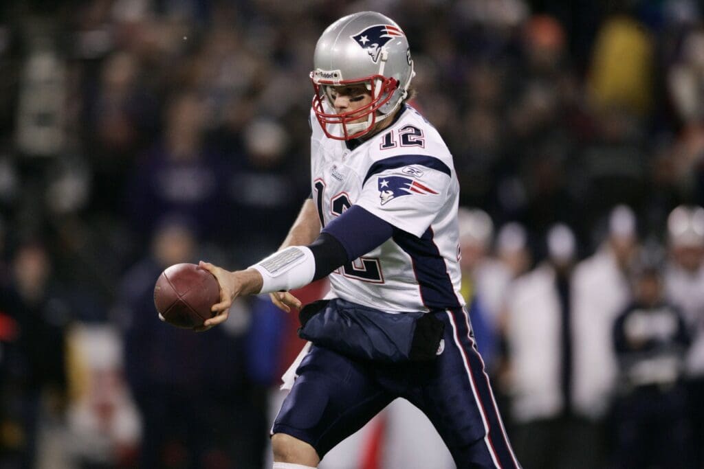 Dec 3, 2007; Baltimore, MD, USA; New England Patriots quarterback Tom Brady (12) hands the ball off in the first quarter against the Baltimore Ravens at M&T Bank Stadium.