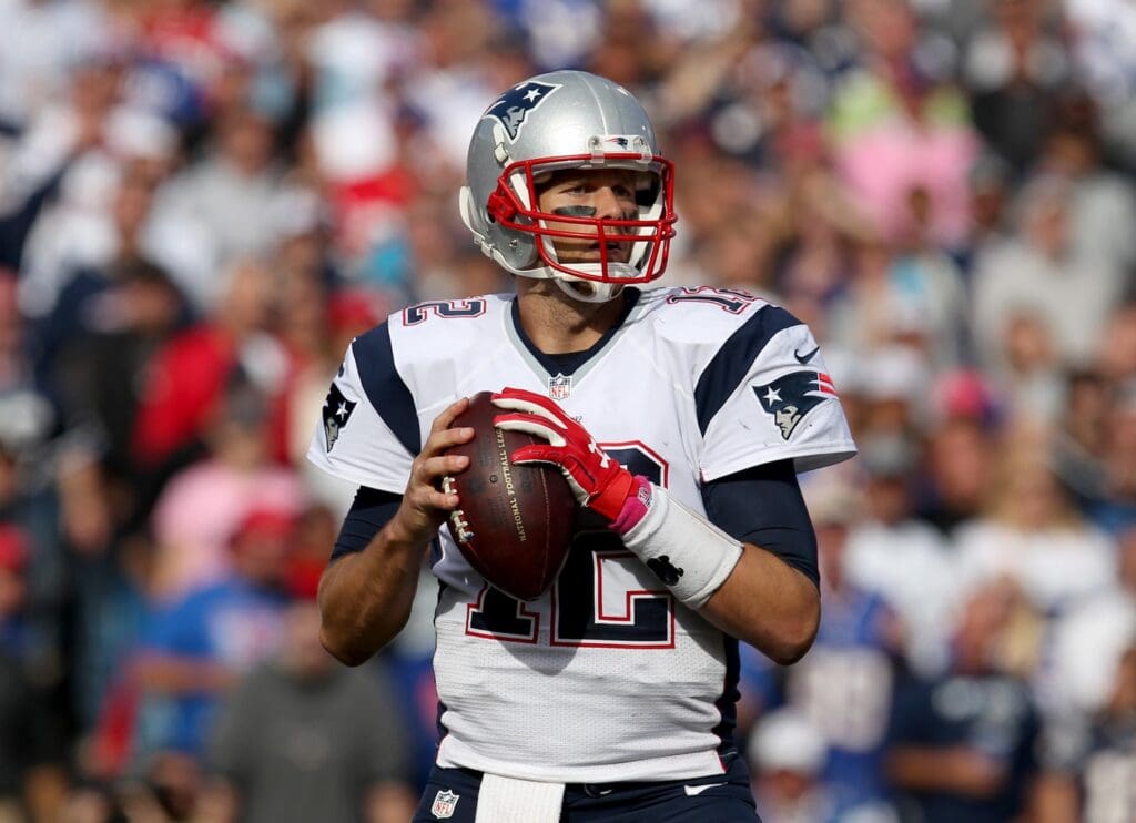 Oct 12, 2014; Orchard Park, NY, USA; New England Patriots quarterback Tom Brady (12) looks to throw a pass against the Buffalo Bills at Ralph Wilson Stadium. New England beats Buffalo 37 to 22.