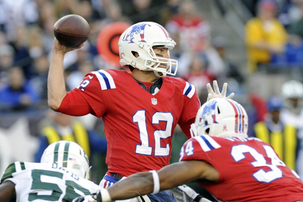 October 21, 2012; Foxboro, MA USA; New England Patriots quarterback Tom Brady (12) makes a pass during the first quarter against the New York Jets at Gillette Stadium.